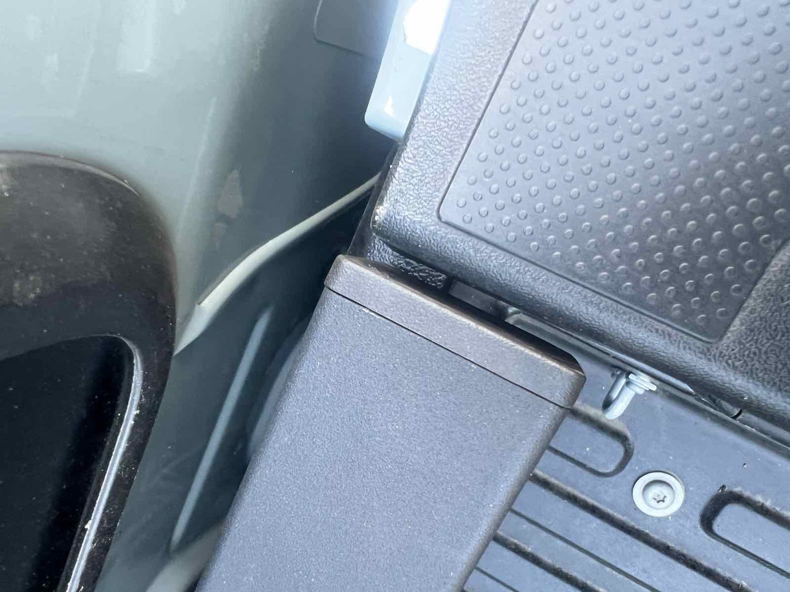 The open corner pocket where the front bed-rail cap meets the side rail near the cab on a 2023 Tacoma, before any butyl tape, showing the gap that lets water and dust in.
