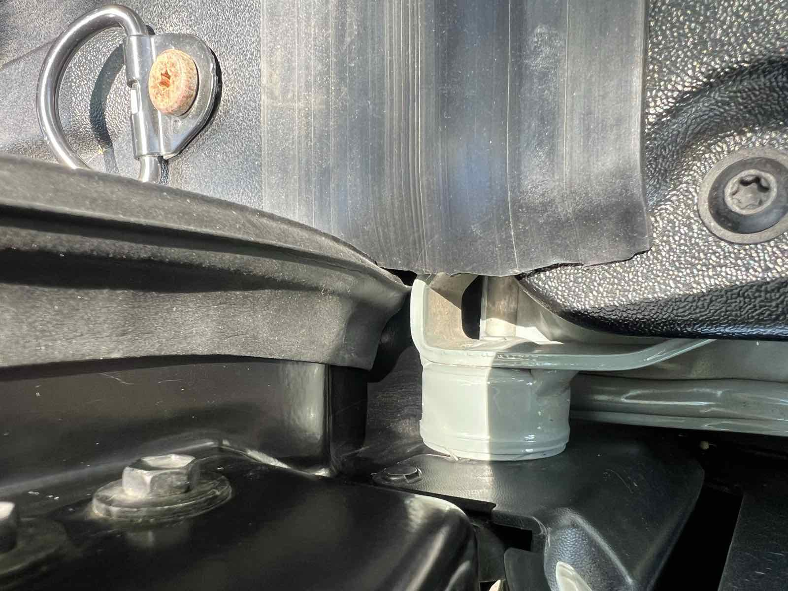 Close-up of the corner where a black ribbed taper seal meets the ROK Block gap cover on a Tacoma, installed in the reverse of the manufacturer's recommended order.