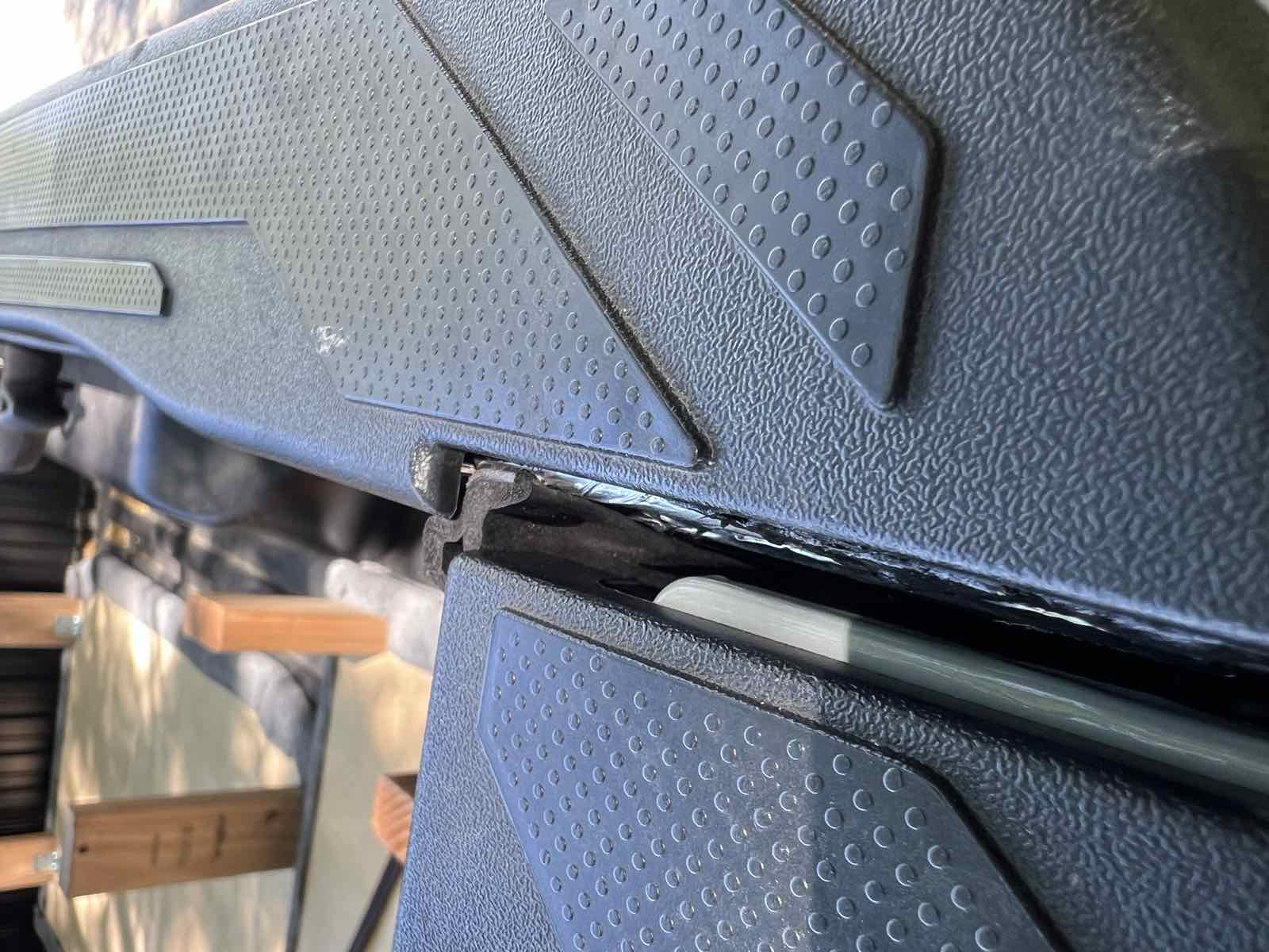 Top-down exterior view of a Tacoma with the tailgate closed and the right-hand taper seal installed, showing how the seal meets the previously sealed bed rail.