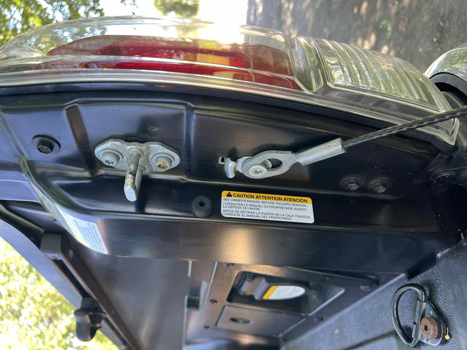 The right-hand bedside of a Tacoma before taper seal installation, with a factory sticker still attached and the surface not yet cleaned.